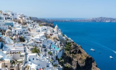 Beautiful Santorini houses overlooking the Aegean Sea on a sunny day.