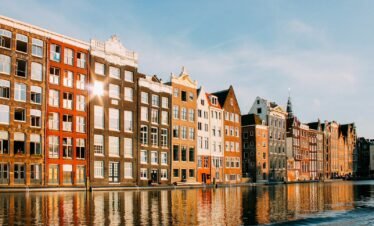 assorted-color buildings beside body of water
