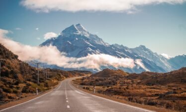 grey road in behind mountain