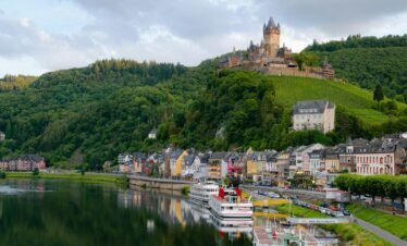 Idyllic landscape of Cochem Castle overlooking Moselle River in Germany.