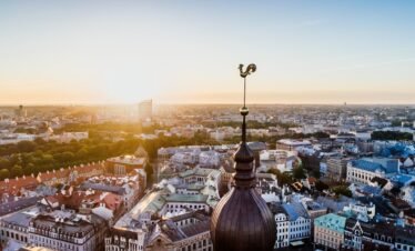 Stunning aerial view of Riga, Latvia with the sun rising over the historic cityscape and skyline.