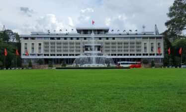 A large building with a fountain in front of it