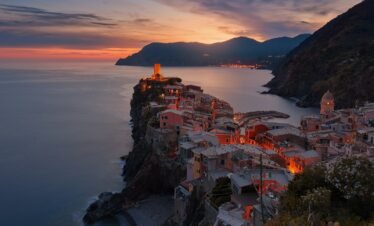 aerial view of village on mountain cliff during orange sunset
