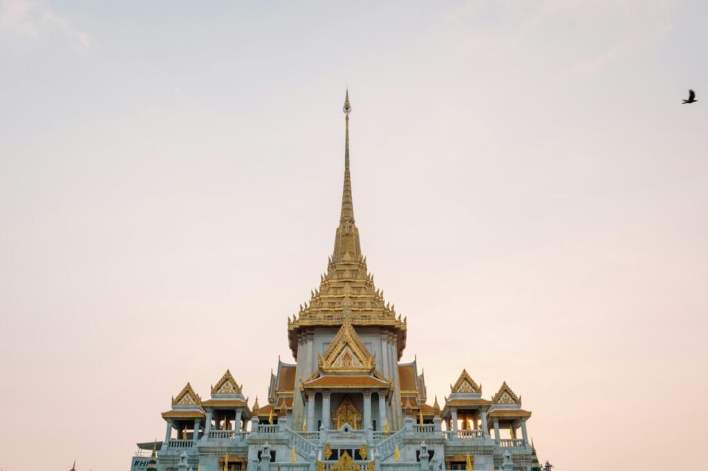 A golden temple stands tall against the sky.
