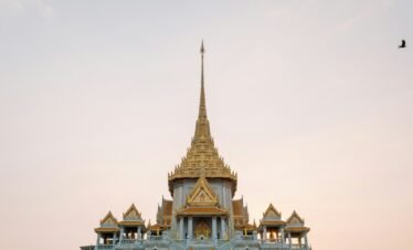 A golden temple stands tall against the sky.