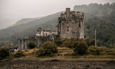 a stone castle on a hill