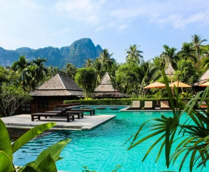 photo of brown bench near swimming pool