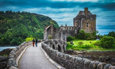 man and woman talking on gray concrete bridge