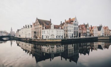 white and brown concrete buildings near bodies of water