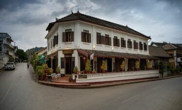 A large white building sitting on the side of a road